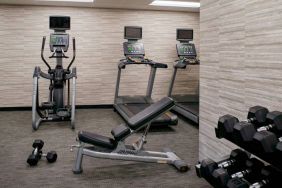 Fitness center equipped with free weights and assorted exercise machines at Sonesta Select Kansas City Airport Tiffany Springs.