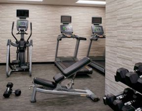 Fitness center equipped with free weights and assorted exercise machines at Sonesta Select Kansas City Airport Tiffany Springs.