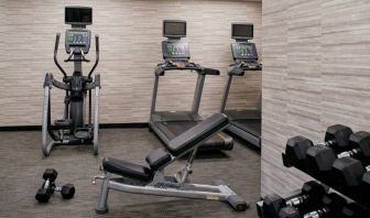 Fitness center equipped with free weights and assorted exercise machines at Sonesta Select Kansas City Airport Tiffany Springs.