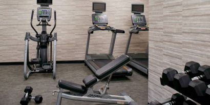 Fitness center equipped with free weights and assorted exercise machines at Sonesta Select Kansas City Airport Tiffany Springs.