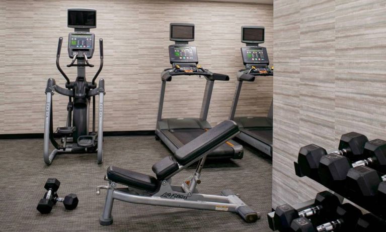 Fitness center equipped with free weights and assorted exercise machines at Sonesta Select Kansas City Airport Tiffany Springs.