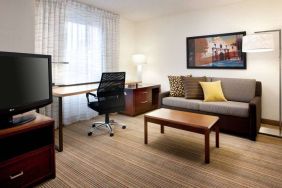 Guest room workspace desk and chair, with TV and sofa nearby, at Sonesta ES Suites San Antonio Downtown Alamo Plaza.