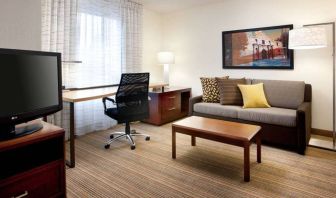 Guest room workspace desk and chair, with TV and sofa nearby, at Sonesta ES Suites San Antonio Downtown Alamo Plaza.