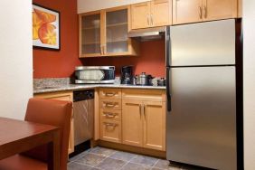 Guest room kitchen fitted with microwave, fridge-freezer, hob, and table at Sonesta ES Suites San Antonio Downtown Alamo Plaza.