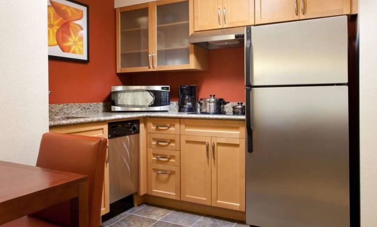 Guest room kitchen fitted with microwave, fridge-freezer, hob, and table at Sonesta ES Suites San Antonio Downtown Alamo Plaza.