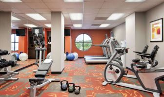 Fitness center with dumbbells, kettlebells, a variety of exercise machines and a TV, at Sonesta ES Suites San Antonio Downtown Alamo Plaza.