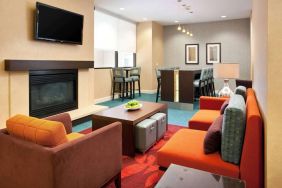 Sonesta ES Suites San Antonio Downtown Alamo Plaza’s lobby lounge has comfy seating, a fireplace, and a wall-mounted TV.