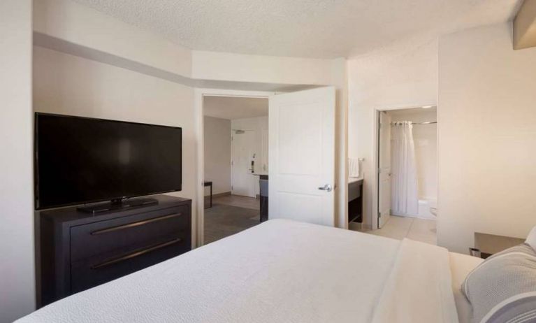 Sonesta ES Suites Reno double bed guest room, including ensuite bathroom and a widescreen TV.