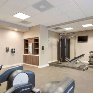 Fitness center equipped with both a range of exercise machines and free weights, plus a TV, at Sonesta ES Suites Reno.