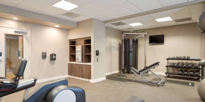 Fitness center equipped with both a range of exercise machines and free weights, plus a TV, at Sonesta ES Suites Reno.