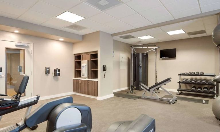 Fitness center equipped with both a range of exercise machines and free weights, plus a TV, at Sonesta ES Suites Reno.