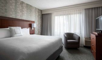 Double bed guest room in Sonesta Select Los Angeles LAX El Segundo, featuring armchair, window, and TV.