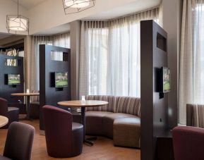 The hotel’s media pods are each furnished with a coffee table, TV, and comfortable seating.