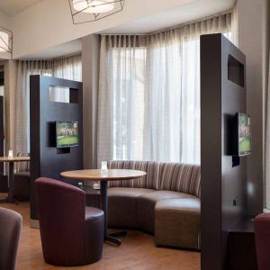 The hotel’s media pods are each furnished with a coffee table, TV, and comfortable seating.