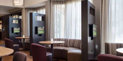 The hotel’s media pods are each furnished with a coffee table, TV, and comfortable seating.