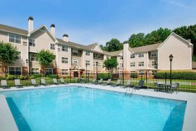 Sonesta ES Suites Atlanta Alpharetta North Point Mall’s outdoor pool has tables and chairs, and sun loungers, by the side.