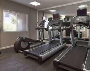 Sonesta ES Suites Tempe’s fitness center has a window, mirrored wall, treadmills, and an elliptical machine.