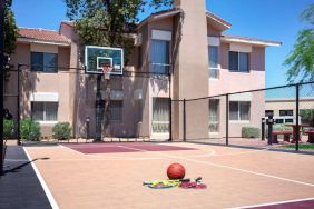 The hotel basketball court has fencing by the hoop, and can also be used for playing tennis.