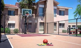 The hotel basketball court has fencing by the hoop, and can also be used for playing tennis.