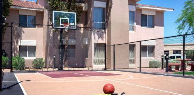 The hotel basketball court has fencing by the hoop, and can also be used for playing tennis.