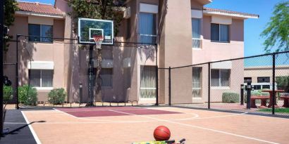 The hotel basketball court has fencing by the hoop, and can also be used for playing tennis.