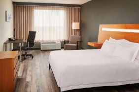 King bed with work desk at Novotel Toronto Vaughan Centre.