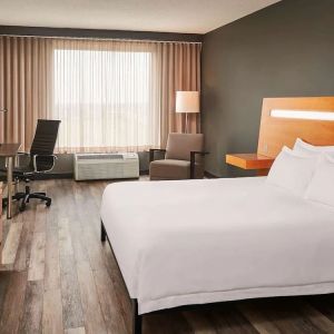 King bed with work desk at Novotel Toronto Vaughan Centre.