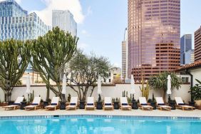 Relaxing outdoor pool with pool chairs at Hotel Figueroa.