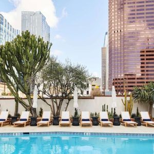 Relaxing outdoor pool with pool chairs at Hotel Figueroa.