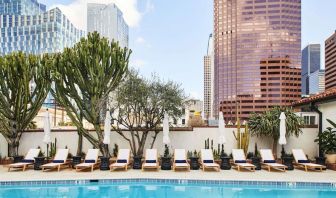 Relaxing outdoor pool with pool chairs at Hotel Figueroa.