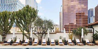 Relaxing outdoor pool with pool chairs at Hotel Figueroa.