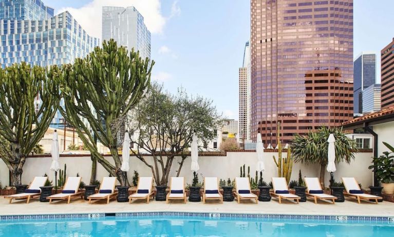 Relaxing outdoor pool with pool chairs at Hotel Figueroa.