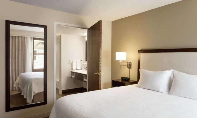 King room with mirror at Hampton Inn & Suites Springdale.