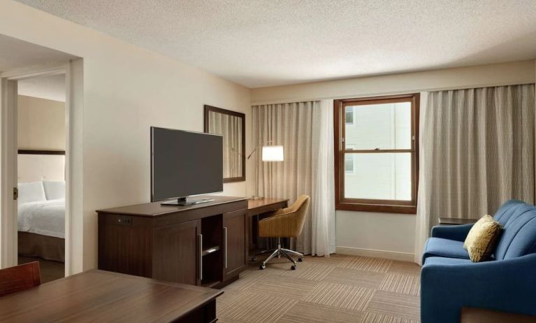 Spacious king room with lounge and work area at Hampton Inn & Suites Springdale.