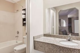 Guest bathroom with shower and bath at Super 8 By Wyndham Houston/Webster.