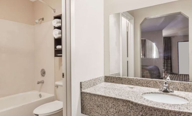 Guest bathroom with shower and bath at Super 8 By Wyndham Houston/Webster.