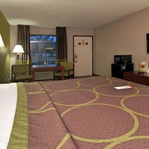 Day room with TV, microwave, and mini-fridge at Super 8 By Wyndham Houston/Webster.