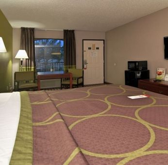 Day room with TV, microwave, and mini-fridge at Super 8 By Wyndham Houston/Webster.