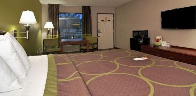 Day room with TV, microwave, and mini-fridge at Super 8 By Wyndham Houston/Webster.