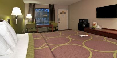 Day room with TV, microwave, and mini-fridge at Super 8 By Wyndham Houston/Webster.