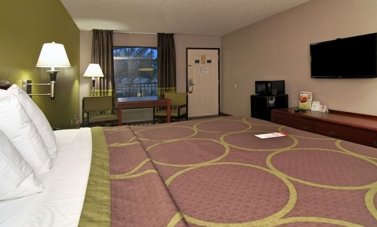 Day room with TV, microwave, and mini-fridge at Super 8 By Wyndham Houston/Webster.