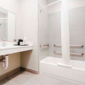 Guest bathroom with shower and bath at Express Inn - Spring.