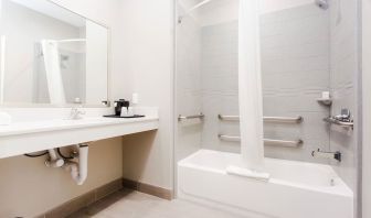 Guest bathroom with shower and bath at Express Inn - Spring.