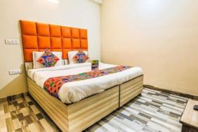 Comfortable king bed at Hotel Smart Stay. 