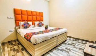 Comfortable king bed at Hotel Smart Stay. 