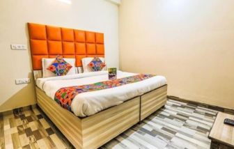 Comfortable king bed at Hotel Smart Stay. 