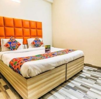 Comfortable king bed at Hotel Smart Stay. 