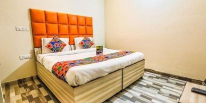 Comfortable king bed at Hotel Smart Stay. 