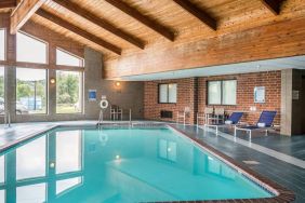 Indoor pool with pool loungers at EnVision Hotel St. Paul South.