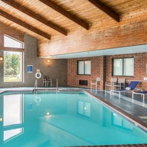 Indoor pool with pool loungers at EnVision Hotel St. Paul South.